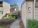 Side view of townhouse entryway with gate and walkway at 925 Wintergreen Blvd, Fern Park, FL 32730