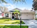 Inviting single-story home with a well-manicured lawn, complemented by a two-car garage and covered entry at 1101 Maidenmoor Rd, Winter Garden, FL 34787