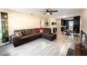 Spacious living room featuring a sectional sofa and wood-look tile floors at 1232 Saint James Rd, Orlando, FL 32808