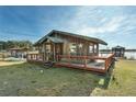 Charming cabin with a wooden deck, rustic facade, and star accents at 15040 Ne 248Th Avenue Rd, Fort Mc Coy, FL 32134