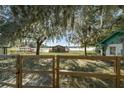 Lakefront property with wooden fence and mature trees at 15040 Ne 248Th Avenue Rd, Fort Mc Coy, FL 32134
