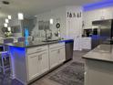 Modern kitchen with white cabinets, island, and stainless steel appliances at 1563 Cross Prairie Pkwy, Kissimmee, FL 34744