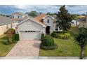 One-story house with a two-car garage, and a spacious backyard at 16067 Shasta St, Clermont, FL 34714