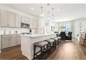 Modern kitchen with an island, pendant lighting, stainless steel appliances, and breakfast bar at 1609 Hill Park Dr, Deltona, FL 32725
