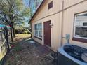 Exterior shot showing a partial view of the backyard with a privacy fence and the exterior of the home at 2101 La Due Ct, Orlando, FL 32811