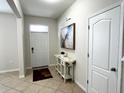 Entryway with tile flooring, console table, and two doors at 2292 Grantham Ave, Davenport, FL 33837