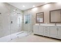Modern bathroom features a spacious glass shower and double vanity with white cabinets at 231 Chestnut Ridge St, Winter Springs, FL 32708