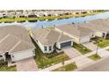 Aerial view of the single-Gathering home situated within a community near a body of water at 2496 Pine Preserve Ct, St Cloud, FL 34771