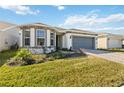 Charming single-story home with a two-car garage, well-maintained lawn, and beautiful brick driveway at 2496 Pine Preserve Ct, St Cloud, FL 34771