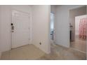 Clean foyer entry with tile floor, white walls, and doorways to the bathroom and other rooms at 253 Golden Sands Cir, Davenport, FL 33837