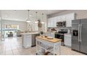 Modern kitchen with white cabinets, stainless steel appliances, and island at 2582 Winsome Way, Davenport, FL 33896