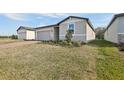 View of a single-story home featuring an attached garage and manicured front yard landscaping at 4543 Sidesaddle Trl, St Cloud, FL 34772
