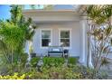 Inviting front porch adorned with lush greenery, decorative pillows, and charming accents for relaxed outdoor living at 4608 Egg Harbor Dr, Kissimmee, FL 34746