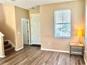 Bright living room featuring laminate flooring, a window, and natural light at 525 Aster Dr, Davenport, FL 33897