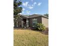 Charming single-story home with a well-maintained lawn, two-car garage, and inviting front entrance at 5610 Forest Ridge Dr, Winter Haven, FL 33881