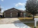 Charming single-story home with a well-maintained lawn, two-car garage, and inviting front entrance at 5610 Forest Ridge Dr, Winter Haven, FL 33881