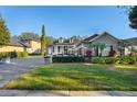 House with a golf cart and manicured lawn at 6001 Caymus Loop, Windermere, FL 34786