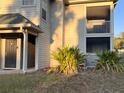 Ground-level condo entrance with a screened-in porch and landscaping at 6088 Westgate Dr # 103, Orlando, FL 32835