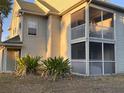 Condo building side view, highlighting a screened balcony at 6088 Westgate Dr # 103, Orlando, FL 32835