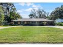 House exterior showcasing a spacious lawn and a two-car garage at 718 32Nd St, Orlando, FL 32806