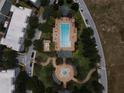 Community pool with surrounding landscaping and parking at 7521 Mourning Dove Cir # 303, Reunion, FL 34747