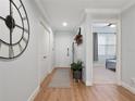 Light and bright entryway with wood floors and a view of a bedroom at 7521 Mourning Dove Cir # 303, Reunion, FL 34747