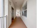 Clean hallway with elevator access and windows at 7521 Mourning Dove Cir # 303, Reunion, FL 34747