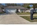 Single story home with well-manicured lawn, visible mailbox with the number 1001 at 1001 Willow Run St., Minneola, FL 34715