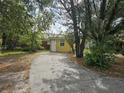 Yellow house exterior with a driveway at 1040 Maxey Dr, Winter Garden, FL 34787