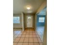 Bright and airy entryway with tile flooring and access to other rooms at 115 Cardamon Dr, Orlando, FL 32825