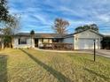 House exterior showcasing a white brick facade and landscaping at 115 Cardamon Dr, Orlando, FL 32825