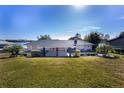 Single-story home with covered entry and large yard at 115 N Lake Florence Dr, Winter Haven, FL 33884