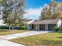 Charming home boasting a well-maintained lawn, lush landscaping, brick-lined driveway, and a spacious two-car garage at 1250 Chichester St, Orlando, FL 32803