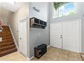 Bright entryway with tiled floors, a coat rack, and a bench at 12666 Moss Park Ridge Dr, Orlando, FL 32832