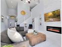 Open living room with sectional sofa, fireplace, and high ceilings at 136 Madiera Beach Blvd, Kissimmee, FL 34746