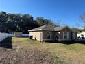 Spacious backyard with a shed and a partial view of a fence at 14476 Se 34Th Ct, Summerfield, FL 34491
