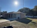 Tan house with a carport and a large yard at 14476 Se 34Th Ct, Summerfield, FL 34491