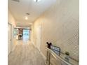 Bright entryway with geometric wallpaper and view into the living area at 1584 Sandbagger Dr, Davenport, FL 33896