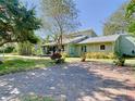 Backyard view with lush landscaping and a brick patio at 1601 Lyndale Blvd, Maitland, FL 32751