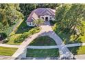 Aerial view of house showing large lot, circular driveway, and landscaping at 1829 Brackenhurst Pl, Lake Mary, FL 32746