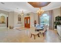 Spacious dining room with large table, chandelier, and hardwood floors at 1829 Brackenhurst Pl, Lake Mary, FL 32746