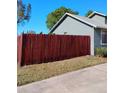 Shot of a home's green exterior paint, bright trim, and mature landscaping at 1886 Elkcam Blvd, Deltona, FL 32725