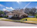 Tan house with a two-car garage and landscaping at 2147 Sunbow Ave, Apopka, FL 32703