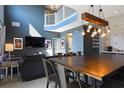 Open concept dining room with a large wooden table and chandelier at 2793 Lido Key Dr, Kissimmee, FL 34747