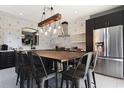 Modern kitchen with dark cabinetry, quartz countertops, and a large island at 2793 Lido Key Dr, Kissimmee, FL 34747