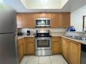 Kitchen with stainless steel appliances and wood cabinets at 3187 Sea World Ct, Kissimmee, FL 34746