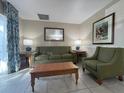Living room with green sofa and armchairs, coffee table at 3187 Sea World Ct, Kissimmee, FL 34746