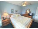 Cozy bedroom with a ceiling fan, comfortable bed, and charming decor at 3197 Sea World Ct, Kissimmee, FL 34746