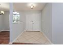 Inviting foyer with tile flooring, neutral paint, and double doors for ample closet space upon entry at 4001 Misty Morning Pl, Casselberry, FL 32707