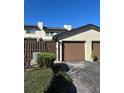 Attached garage, a well-kept lawn, and plants create a warm welcome to the property at 607 Waverly Ln # 403, Maitland, FL 32751